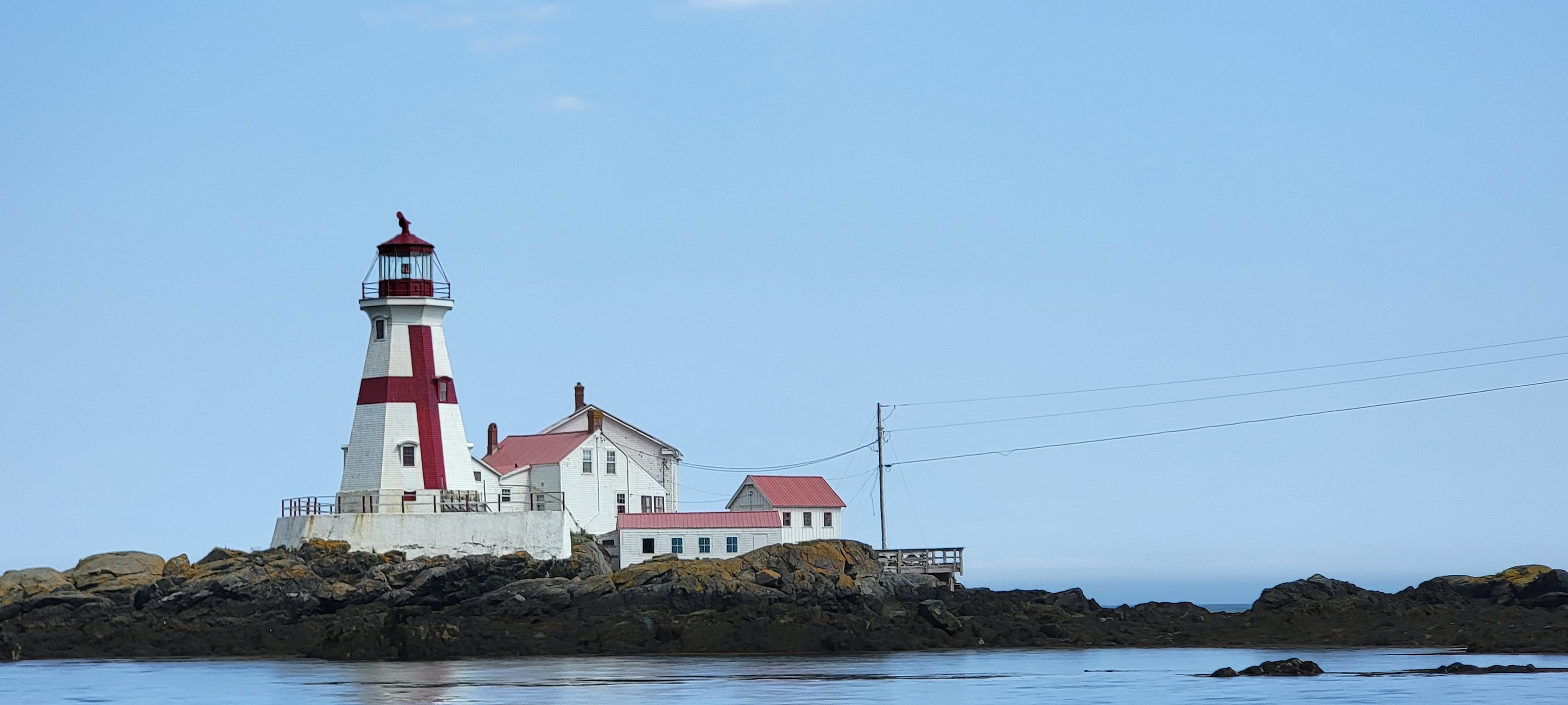 View of lighthouse from the water in Maine